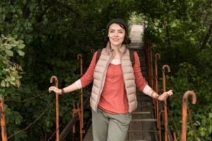 mid-shot-woman-passing-wooden-bridge_23-2148693712